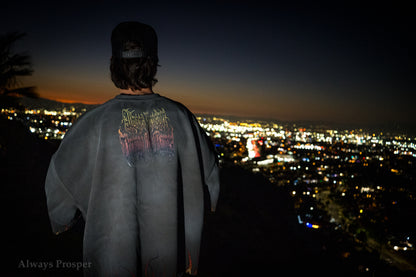 Back of the Through the Flames tee worn on a hillside above the city lights at night