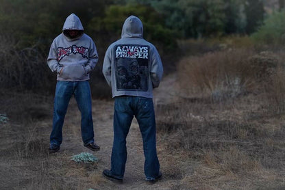 Two models wearing the Always Prosper Scream stone grey hoodie outdoors at dusk, front and back