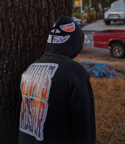 Jack-O-Lantern hoodie worn with the hood up, pumpkin face and stacked Always Prosper back print visible